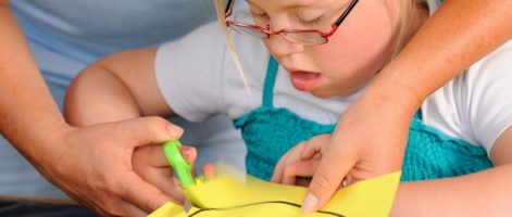 Child with a disability working on a craft