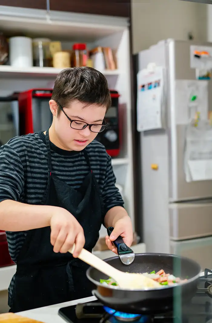 Image of a young man cooking food