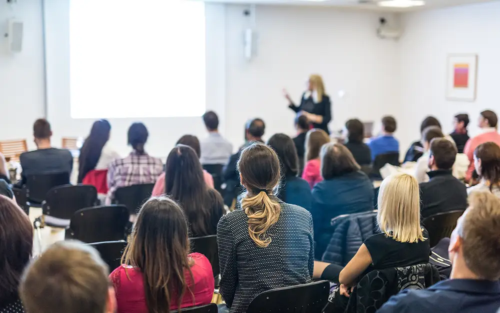 Classroom setting with teacher in front of students