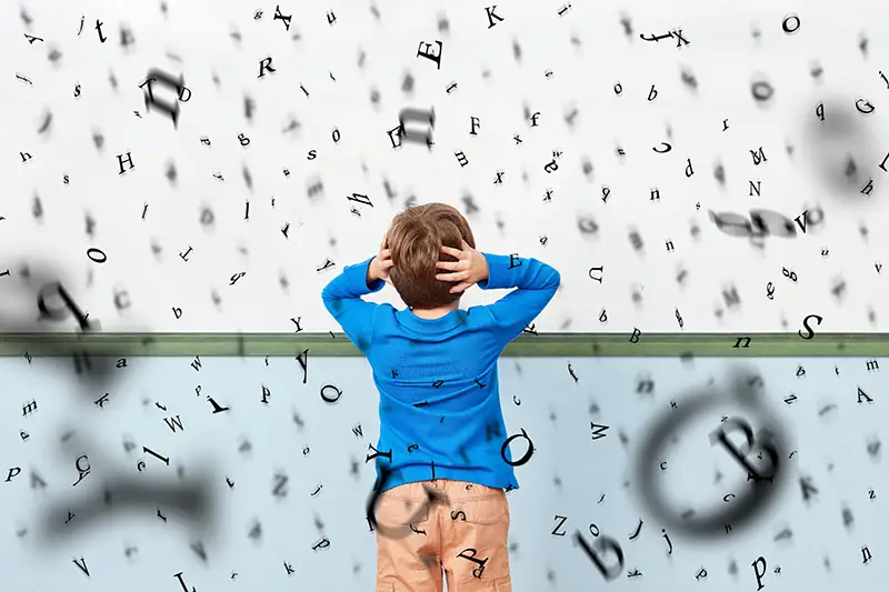 Graphic of letters flying in the air with a boy with his hands to his head