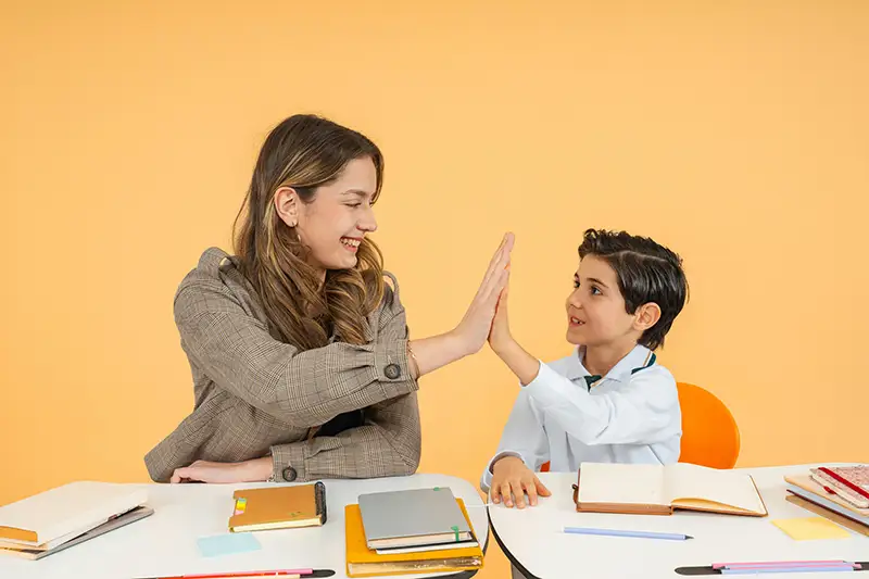 Lady high fiving a young person